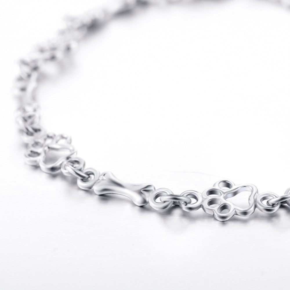 ZILVEREN HONDENPOOT EN BOT BEDELARMBAND